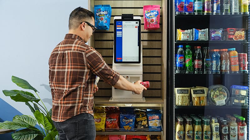 On-site workplace micro market with coolers, shelves, snacks, and drinks.
